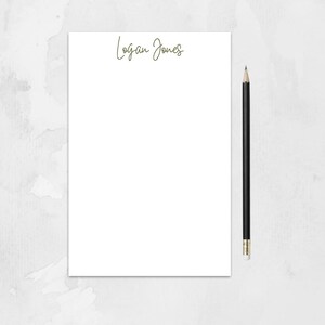 May include: A white notepad with the name "Logan Jones" written in cursive at the top.