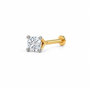 May include: A gold labret stud earring featuring a square-cut clear gemstone held by four silver-toned prongs. The post is gold-colored and terminates in a flat, circular disc backing, designed for secure placement in a piercing.