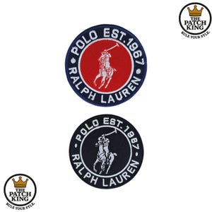 May include: Two circular embroidered patches with the Ralph Lauren Polo logo. One has a red centre with a white polo player, surrounded by a navy border. The other has a white polo player on a black background.