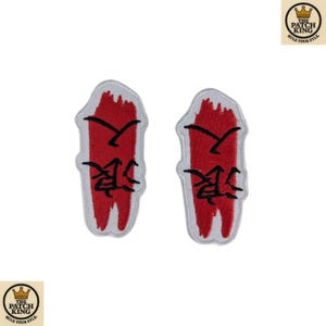 May include: Two embroidered patches with a red background and white border. Each patch features black Japanese characters and a black brushstroke design. The patches are from The Patch King.