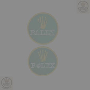 May include: Two circular patches featuring the Rolex logo. Each patch has a light green background with a gold crown and the word "ROLEX" in white. The patches are surrounded by a thin yellow border.