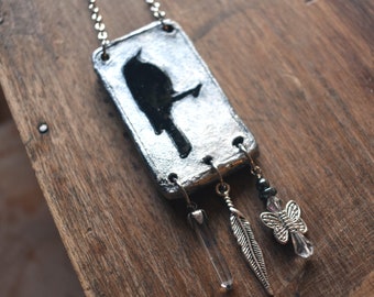 Necklace Crow Relief in Clay Silver & Black Color on Nickel Plated Steel Chain with 3 Dangles Quartz Crystal Feather Butterfly