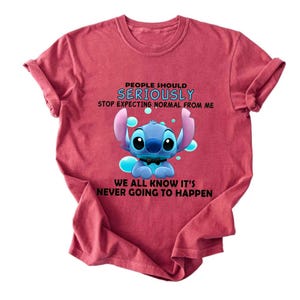 May include: A white ceramic mug with a black handle and the text "But First, Coffee" in a black, handwritten-style font. The mug is on a white surface.