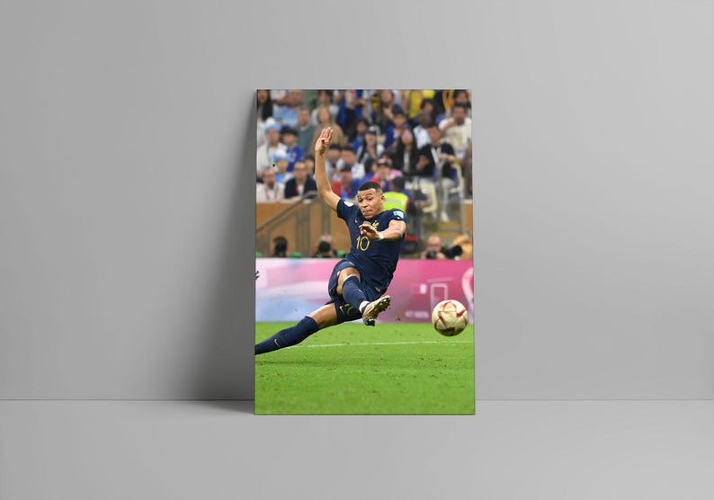 May include: A framed print of a soccer player in a navy blue uniform kicking a soccer ball on a green field. The player is wearing the number 10. The background shows a crowd of people.