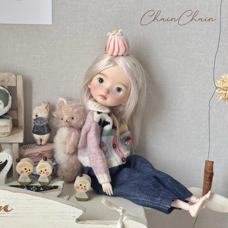 Blythe doll wearing handmade patchwork knitted cardigan with mushroom and flower patterns