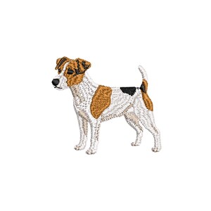 May include: Embroidered image of a Jack Russell Terrier dog. The dog has a white coat with brown and black markings. The dog is standing, facing left, with its tail slightly curved.