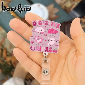 May include: A pink and white badge reel with the text "DIGESTIVE DIVAS" and illustrations of internal organs. The badge reel has a clear plastic strap and a metal clip.