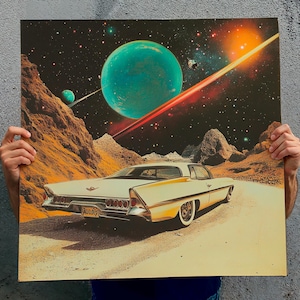 May include: A vintage white car with gold detailing is shown on a desert road, set against a backdrop of a vibrant space scene with planets and a shooting star. The artwork has a retro, science fiction theme.