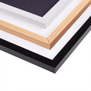a close-up view of a stack of four different colored picture frames, including black, white, and light brown.
