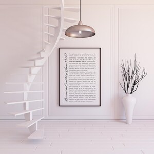 May include: A minimalist interior featuring a white spiral staircase, a framed print with text, a tall white vase with branches, and a silver pendant light. The text on the print reads "Lessons in Gentility, Anne 1860."