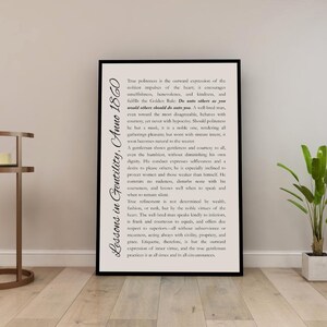 May include: A framed print with black borders, featuring text from "Lessons in Gentility, Anno 1860." The text is in a classic serif font on an off-white background. The print is displayed in a well-lit room with a plant.