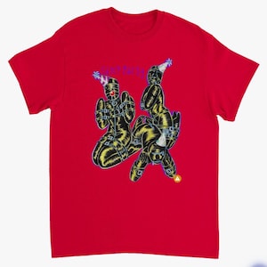 May include: Red t-shirt with a graphic illustration of three figures in black and yellow attire, wearing party hats. The text "Sane Party" is written in blue above the figures.