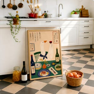 May include: A framed illustration featuring a white goose wearing a blue polka-dot neckerchief, sitting at a green table with a glass of red wine. The artwork includes Japanese text, plates of food, a wine bottle, and a small orange vase.