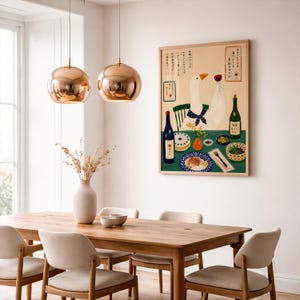 May include: A rectangular wall art print featuring a white goose wearing a blue polka dot scarf, sitting at a green table with wine, plates of food, and Japanese text. The illustration is framed in light wood and displayed on a white wall.