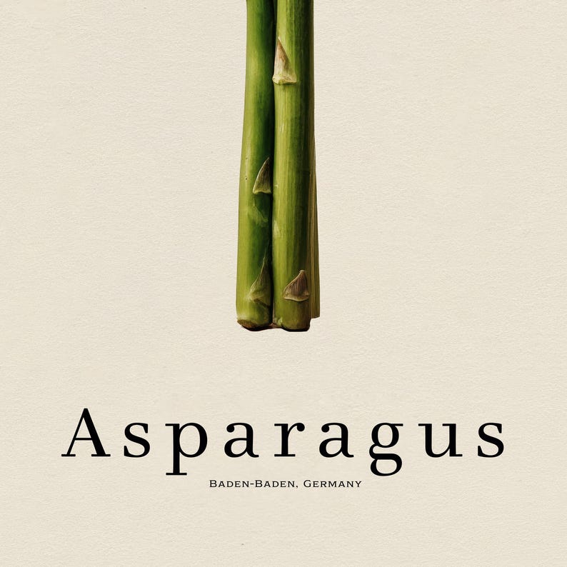 May include: Close-up of fresh green asparagus stalks against a cream-colored background. The word "Asparagus" is printed in a serif font below the stalks, with "BADEN-BADEN, GERMANY" underneath.