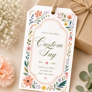 May include: A white custom tag with floral border and the text "Custom Tag". The tag has a decorative floral border with orange, pink, purple, and yellow flowers. The tag is tied with a natural twine string.