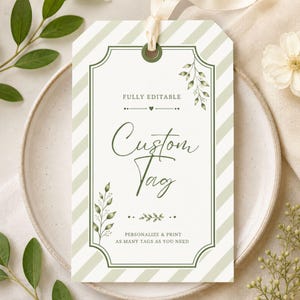 May include: A custom tag with a cream background and green accents. The tag features a decorative border and diagonal stripes. The words "Custom Tag" are written in elegant script. The tag also includes the phrases "FULLY EDITABLE" and "PERSONALIZE & PRINT AS MANY TAGS AS YOU NEED".