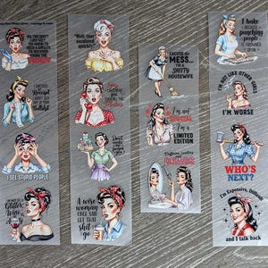 May include: A collection of transparent bookmarks featuring vintage-style illustrations of women with humorous quotes. The bookmarks showcase various designs, including images with text like "I'm not special, I'm a limited edition" and "Who's next?"