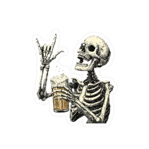 May include: A black and white illustration of a skeleton holding a beer mug with foam, giving the rock and roll hand gesture. The skeleton is smiling with its mouth open. The beer mug is filled with a golden liquid.