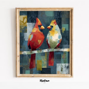 Puede incluir: Una impresión artística enmarcada con dos cardenales estilizados posados en una rama. Las aves están pintadas en tonos rojos, amarillos y blancos sobre un fondo texturizado azul y verde. El marco es de madera clara y la impresión tiene un estilo retro.