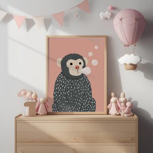 May include: A framed illustration of a monkey blowing bubbles, set against a pink background. The monkey is gray with white spots and a light brown face. The room is decorated with pink accents, including a hot air balloon and bunting.