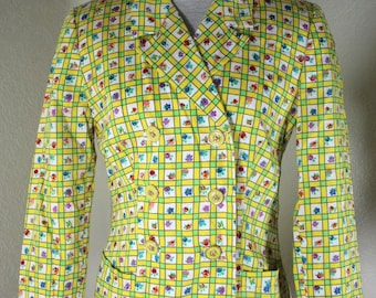 May include: A yellow blazer with a green and white checkered pattern and small floral print. The blazer has a double breasted closure with four buttons.