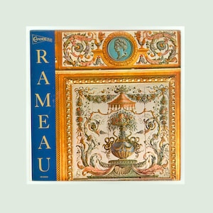 May include: A decorative tile panel featuring ornate floral and classical designs. The panel has a blue and gold frame, with the word "RAMEAU" in blue on the left side. The central design includes a vase with flowers and a decorative canopy.