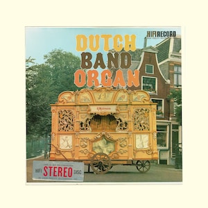 May include: A vintage record album cover featuring a colorful illustration of a Dutch band organ with the text "Dutch Band Organ" in large, bold letters. The organ is decorated with intricate carvings and is set against a backdrop of a quaint European street scene.