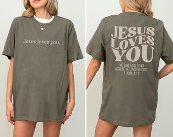 Jesus Loves You T-Shirt, Christian Graphic Tee, Faith-Based Apparel, Bible Verse Shirt 1 John 4:19, Jesus Is King Tee