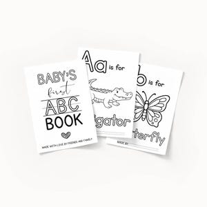 May include: Three black and white baby ABC books. One book reads "BABY'S first ABC BOOK" with a heart. The other two books show the letters "A" and "B" with illustrations of an alligator and a butterfly.
