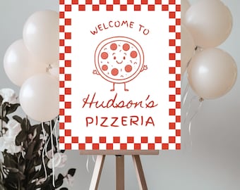 May include: A white sign with a red checkered border and the words "WELCOME TO Hudson's PIZZERIA" in red script. The sign features a cartoon pizza with a smiling face. The sign is displayed on a wooden easel, with white balloons and flowers in the background.