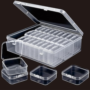 May include: A clear plastic storage box with a hinged lid, divided into multiple small compartments. Several individual clear square containers are also shown, each with a hinged lid. The box and containers are designed for organising small items.