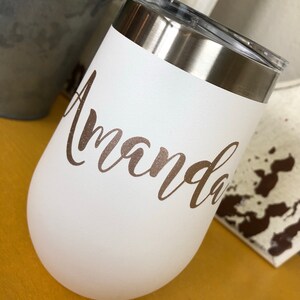 May include: White stainless steel tumbler with a gold glitter name "Amanda" on the side.