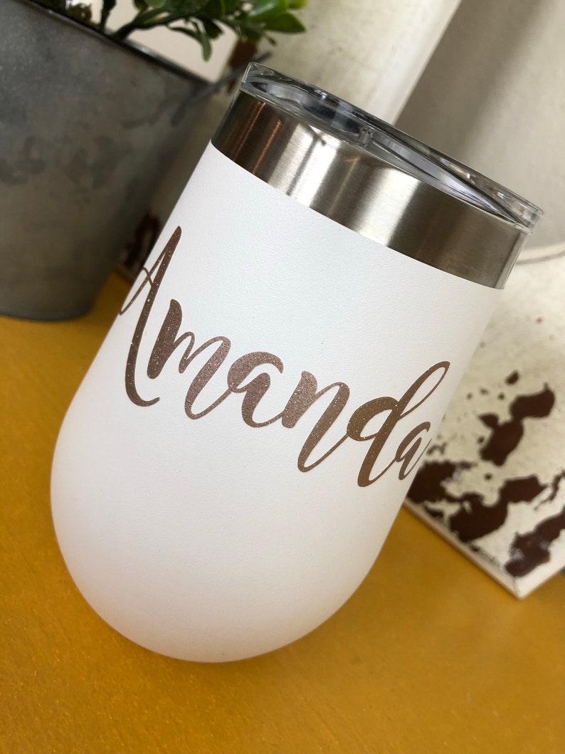 May include: White stainless steel tumbler with a gold glitter name "Amanda" on the side.