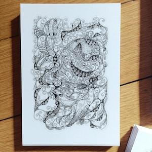 May include: A rectangular white card featuring a dense, intricate black ink drawing composed of swirling lines, loops, and geometric patterns. The artwork fills the center of the card, creating a complex, abstract design with varying line weights.