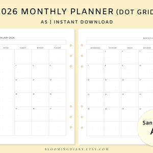 May include: A two-page spread of a 2026 monthly planner with a dot grid layout. The planner is A5 size and available as an instant download. The January 2026 calendar is displayed, with a sans-serif font. The website bloomingdiary.etsy.com is visible.