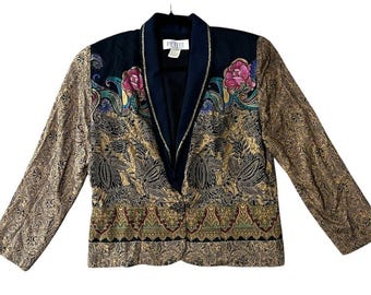 May include: A vintage Petite blazer with a black collar and lapel. The sleeves and body feature a gold and black paisley pattern. The blazer has a floral design with pink and green accents.