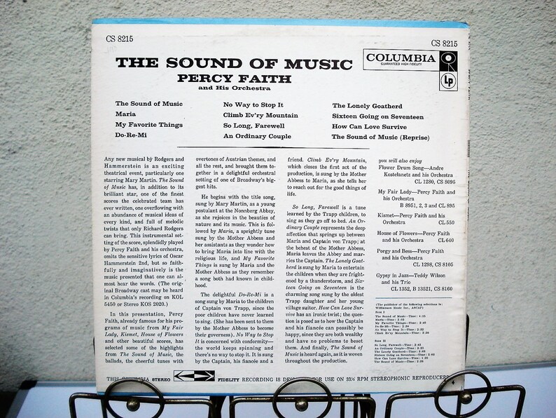 May include: A vintage vinyl record album cover for "The Sound of Music" by Percy Faith and His Orchestra. The album features song titles like "Maria" and "My Favorite Things" and the Columbia Records logo.
