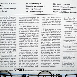 May include: A vintage vinyl record album cover for "The Sound of Music" musical, with song titles and artist information. The cover is white with black text, displaying the album's tracklist and details.