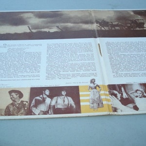 May include: A vintage record album cover featuring a black and white photo of a horse-drawn carriage. The album cover also includes text about the musical "Oklahoma!" and features photos of the cast members. The album cover is in good condition with some wear and tear.