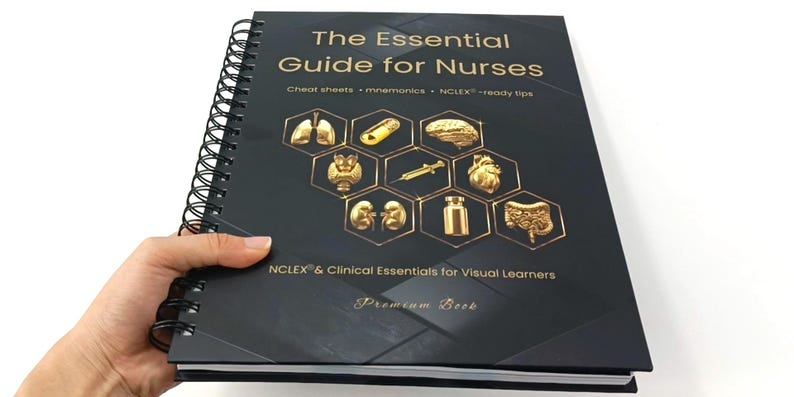 May include: A black spiral-bound book titled "The Essential Guide for Nurses." The cover features gold-colored illustrations of anatomical elements and the text "NCLEX & Clinical Essentials for Visual Learners." The book is held by a hand.