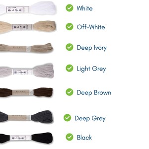 May include: A selection of embroidery thread in various colors, including white, off-white, deep ivory, light grey, deep brown, deep grey, and black. Each spool is labeled with Japanese text and color names.
