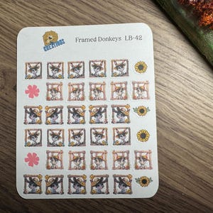 May include: A sheet of stickers featuring framed donkey illustrations, sunflowers, and pink flower accents. The stickers have a white background and are labeled "Framed Donkeys LB-42" with a logo.