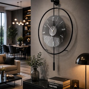 May include: A circular wall clock featuring a black metal frame and a dark glass face with silver-toned hour markers and hands. The clock includes a vertical black metal rod extending above and below the circular frame, ending in a small weight.