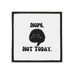 May include: Square patch with a black border and a white centre. The patch features a black cartoon cat with the text "NOPE. NOT TODAY." in a bold, rounded font. The cat has two round eyes and a downturned mouth.
