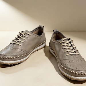 Minimal beige leather flats styled outdoors in natural sunlight