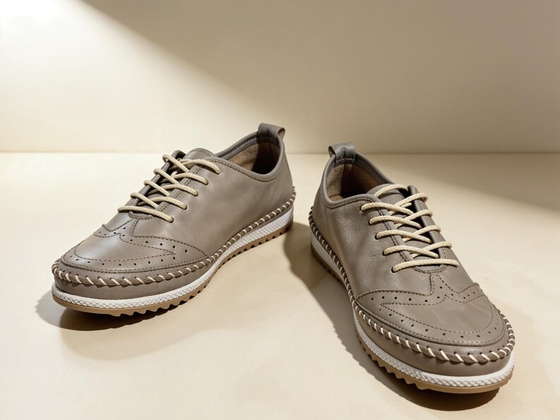 Minimal beige leather flats styled outdoors in natural sunlight