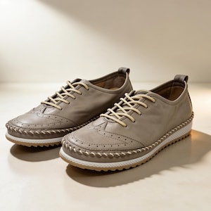 Soft beige leather women’s walking shoes with lace-up front and stitched trim