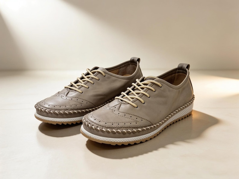 Soft beige leather women’s walking shoes with lace-up front and stitched trim