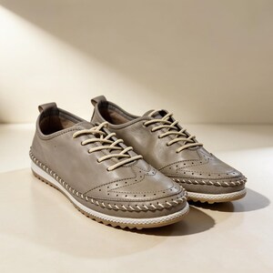 Side view of beige handmade leather flats with flat sole and everyday design